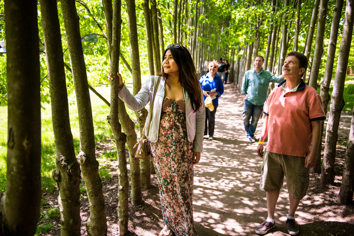 A group of four people in the Red Maple Allée during a team building workshop.