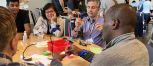 A group of five adults participating in a team building activity.