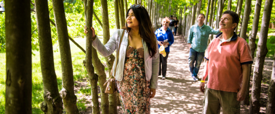 A group of four people in the Red Maple Allée during a team building workshop.