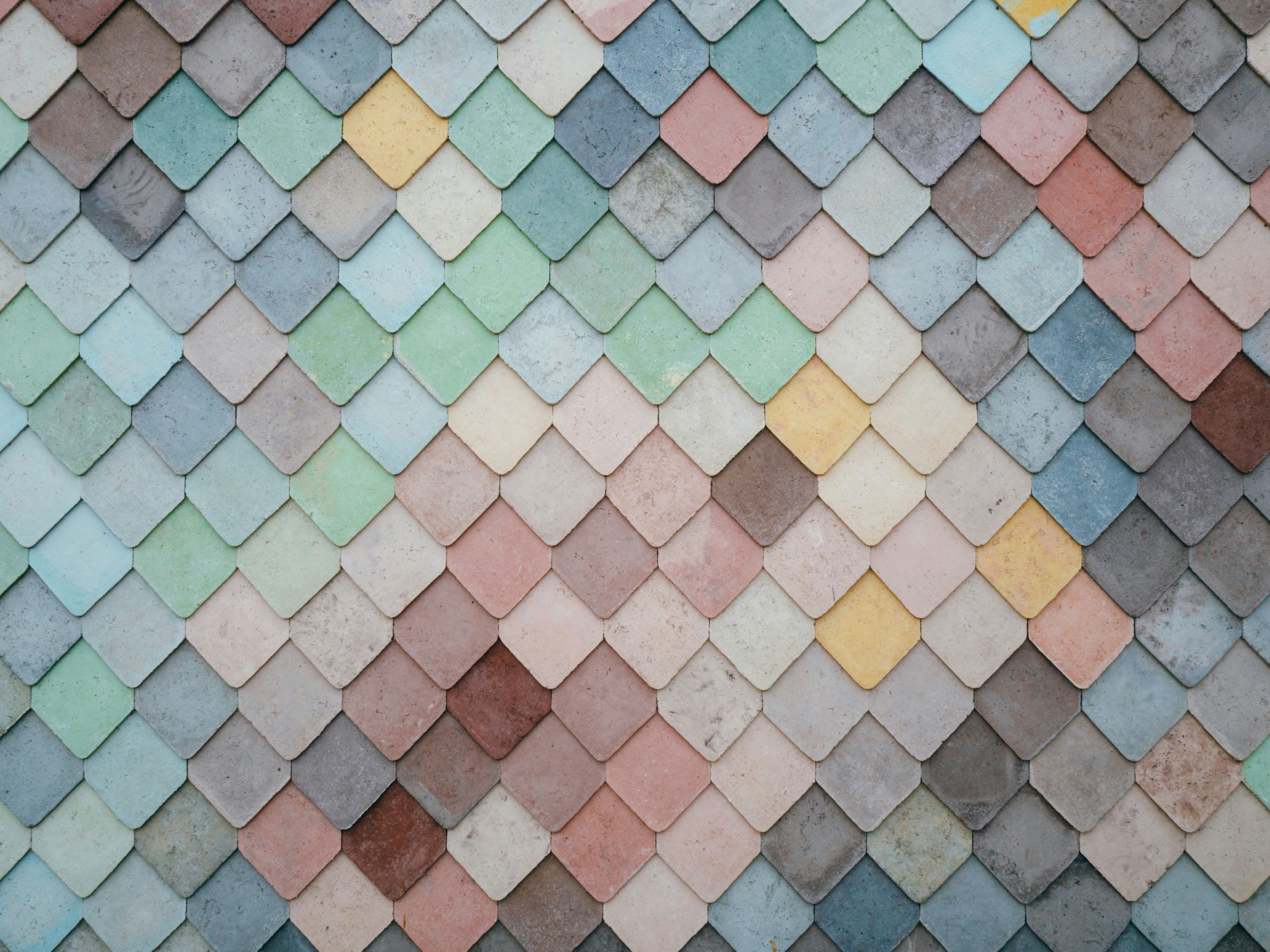 Multicolored interlocking tiles in a geometric formation.