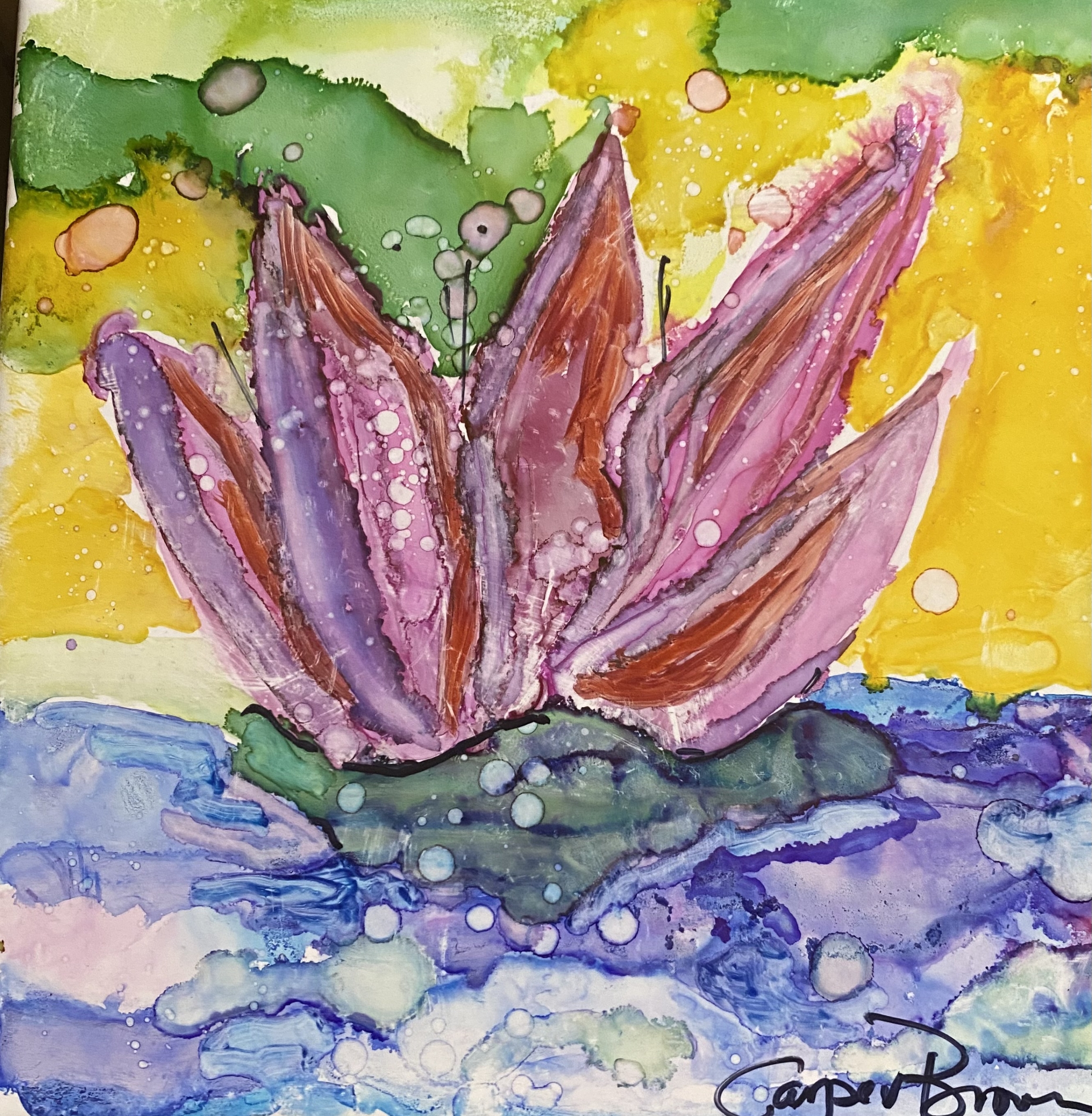 A tile with a painted lotus flower on it.
