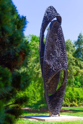 A side view of FOCI, a sculpture made of recycled rubber tires.