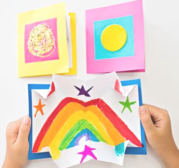 An unfolded pop up card with a rainbow.
